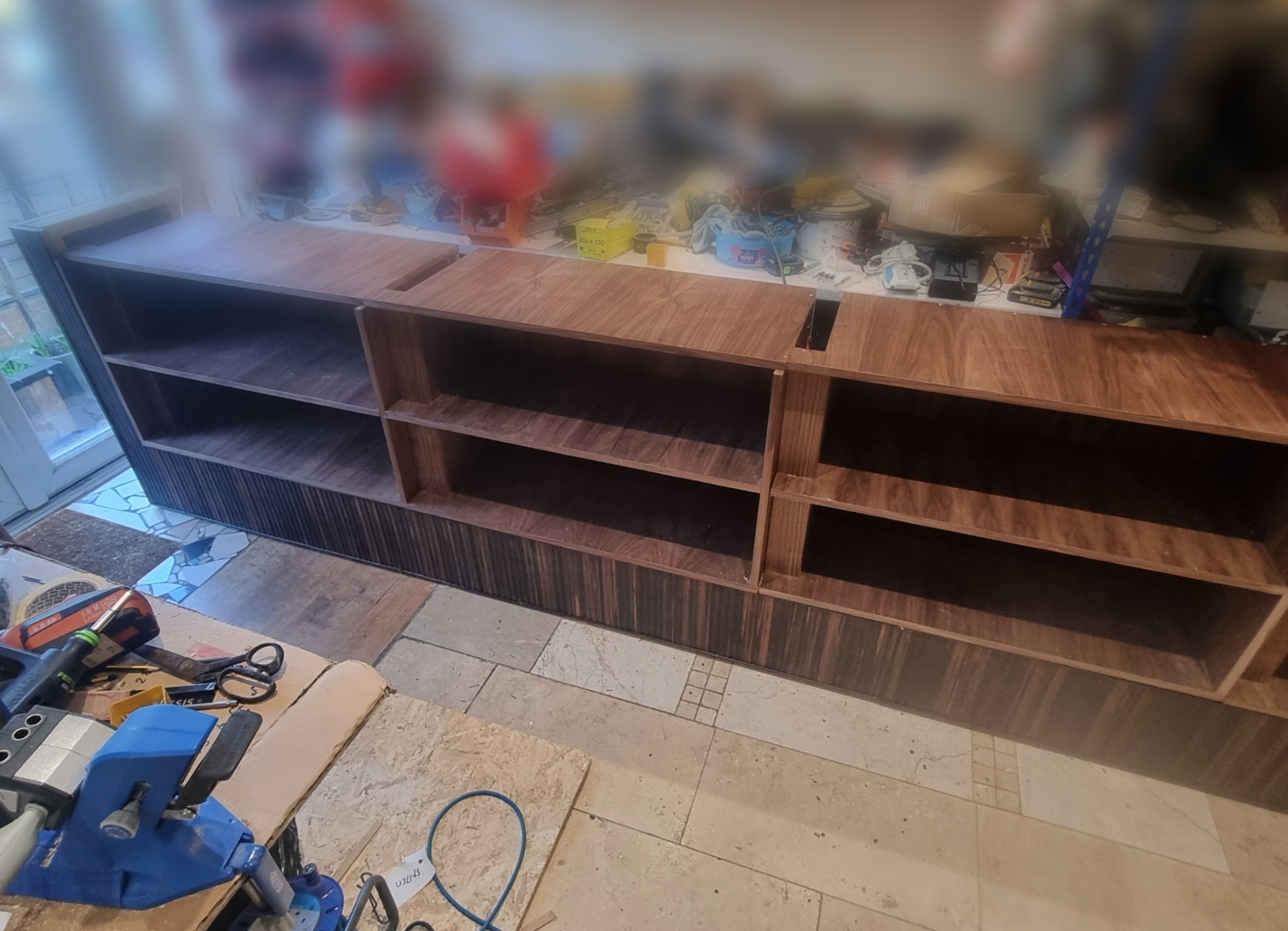 Modular walnut display joinery assembled in the Kustom Made workshop