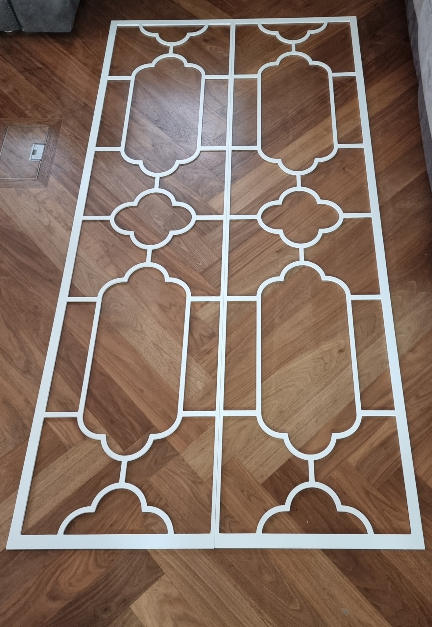 Pair of decorative fretwork panels laid out for inspection