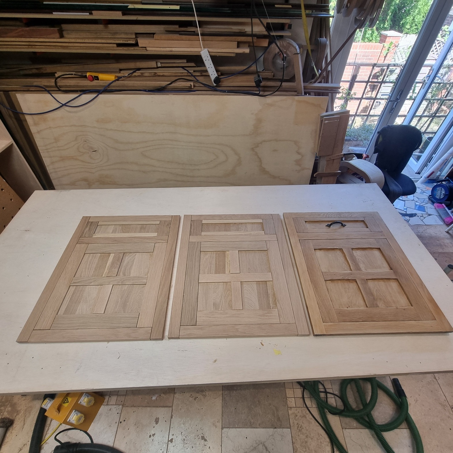 Shaped panel components on the CNC bed in the Kustom Made workshop