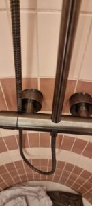 Exposed Dornbracht VAIA shower valve perfectly installed on a curved tiled wall using custom 3D-printed shims by Kustom Made Ltd.
