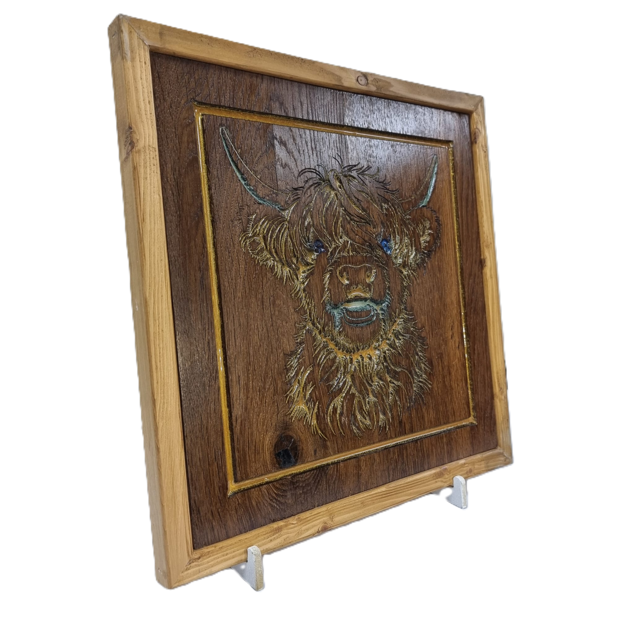 Left-angled view of Highland cow resin inlay wood carving framed in natural softwood
