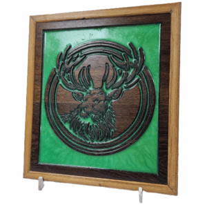 CNC-carved Highland Stag wall art with green resin inlay and stained wood frame, angled view