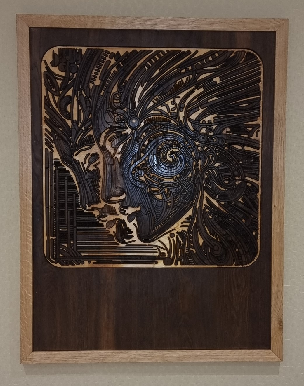 Completed Enigmatic Harmony wood carving with intricate detailing and solid oak frame.