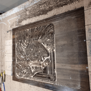 CNC carving process of The Enigmatic Harmony wood artwork on reclaimed oak panels.
