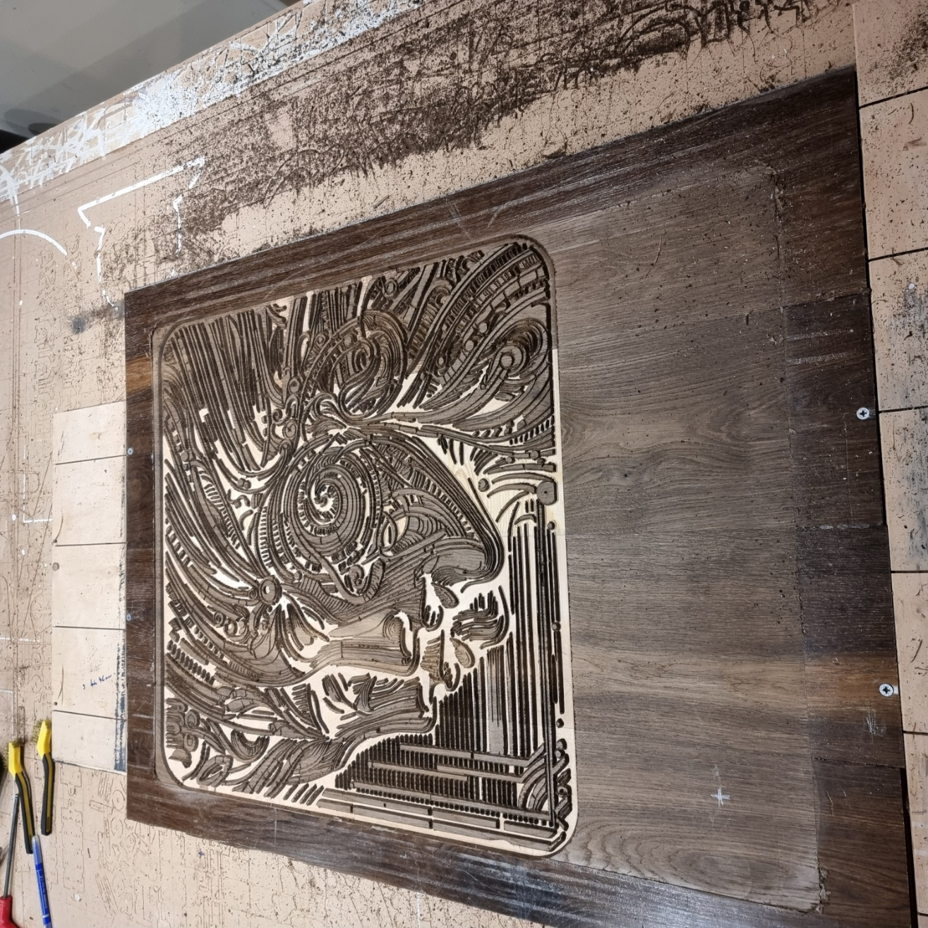 CNC carving process of The Enigmatic Harmony wood artwork on reclaimed oak panels.