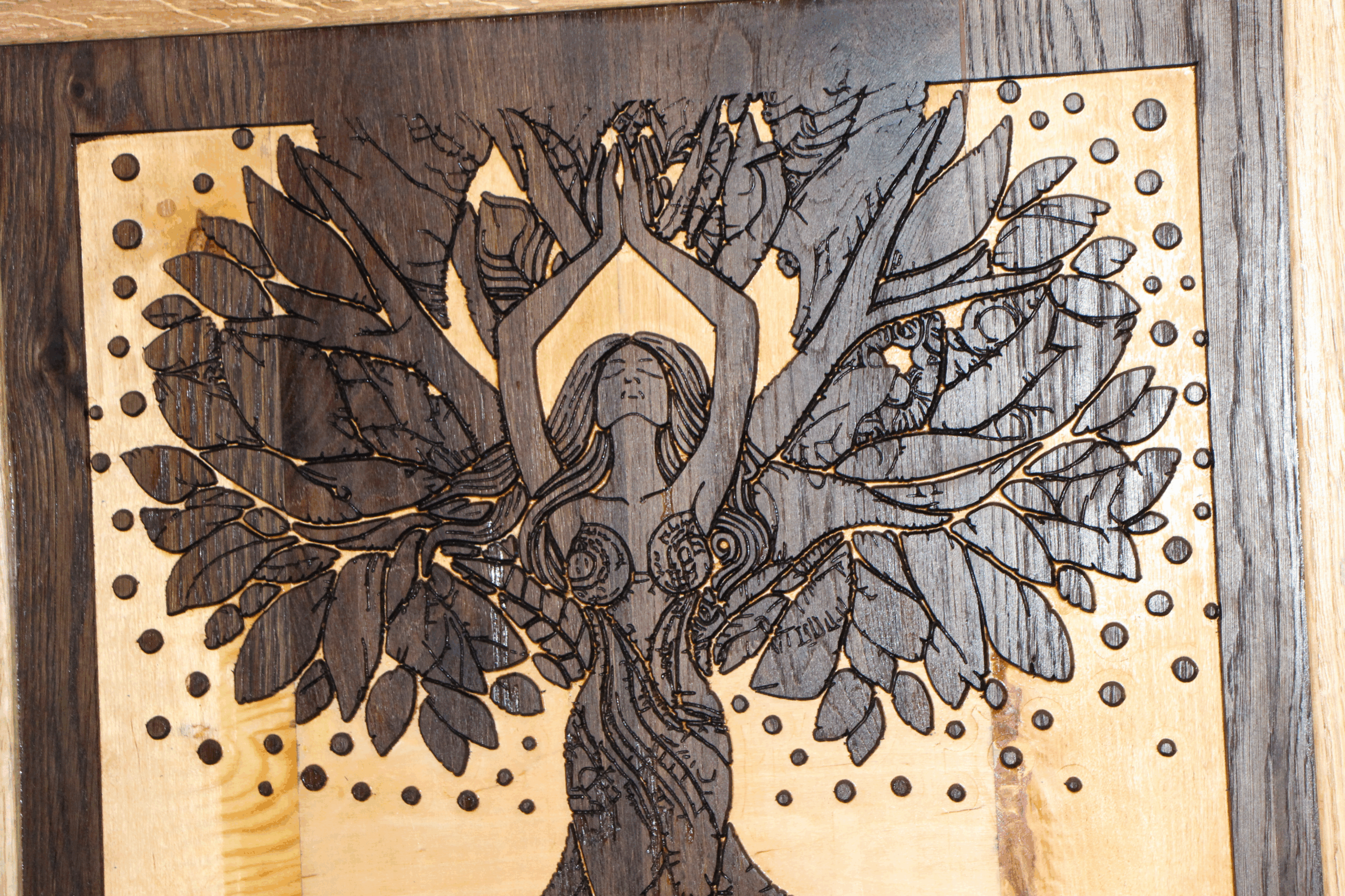 Close-up of the intricate goddess figure and leaf patterns in the Woodland Echoes: The Tree of Serenity reclaimed wenge wood carving