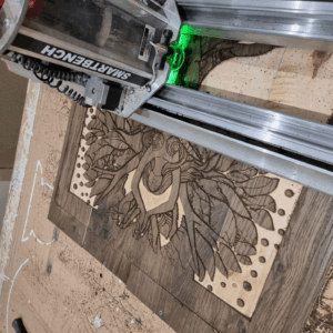 Woodland Echoes: The Tree of Serenity being carved on a Yeti SmartBench CNC machine, showing detailed linework and reclaimed wenge wood surface.
