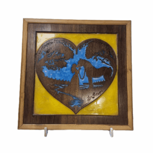 Front view of handcrafted heart-shaped wood carving of girl kissing horse with blue and yellow resin background