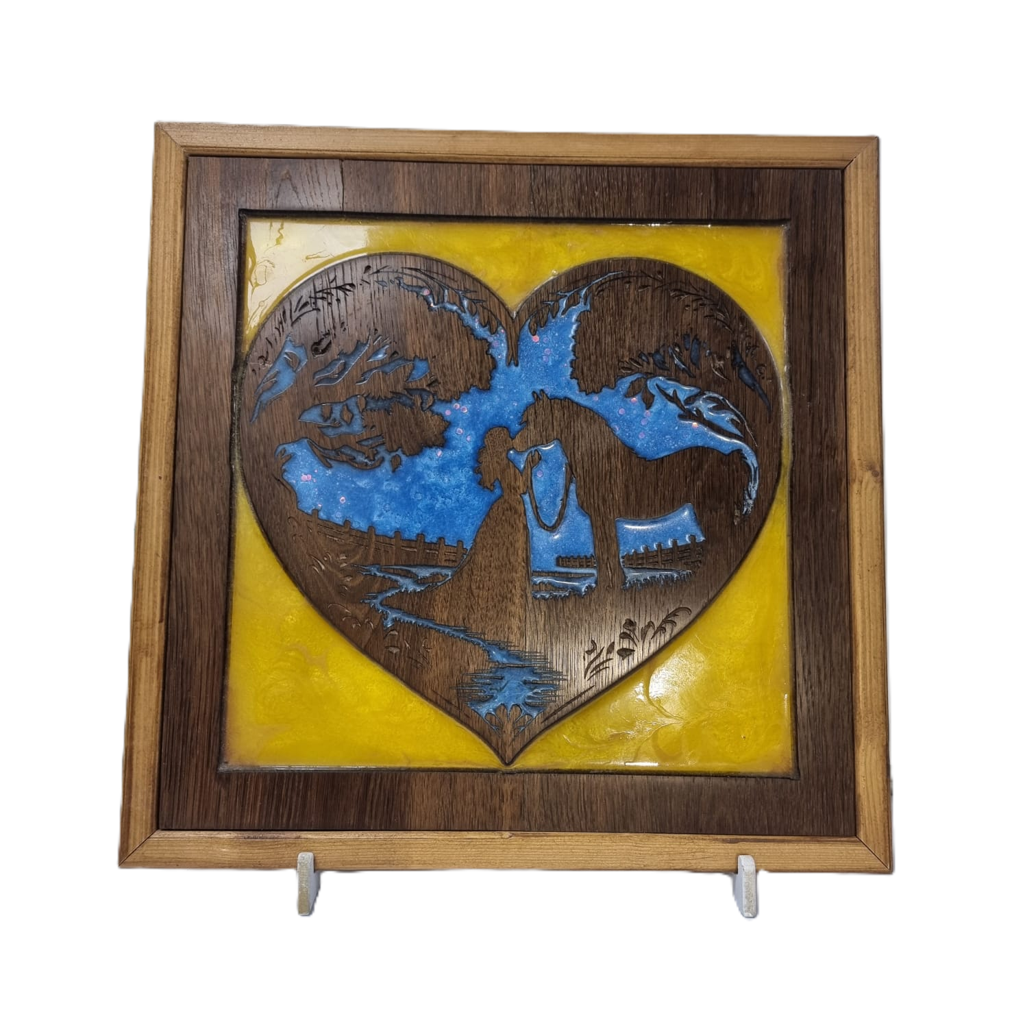 Front view of handcrafted heart-shaped wood carving of girl kissing horse with blue and yellow resin background