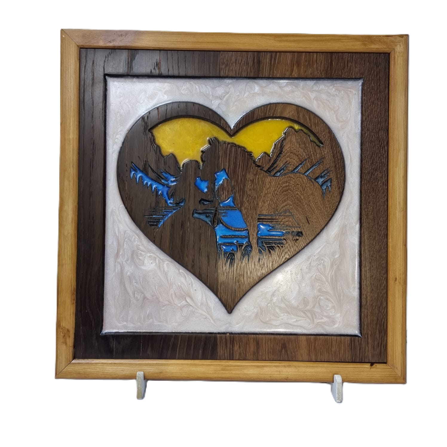 Wooden heart silhouette carving of a girl kissing her horse with blue and yellow resin background