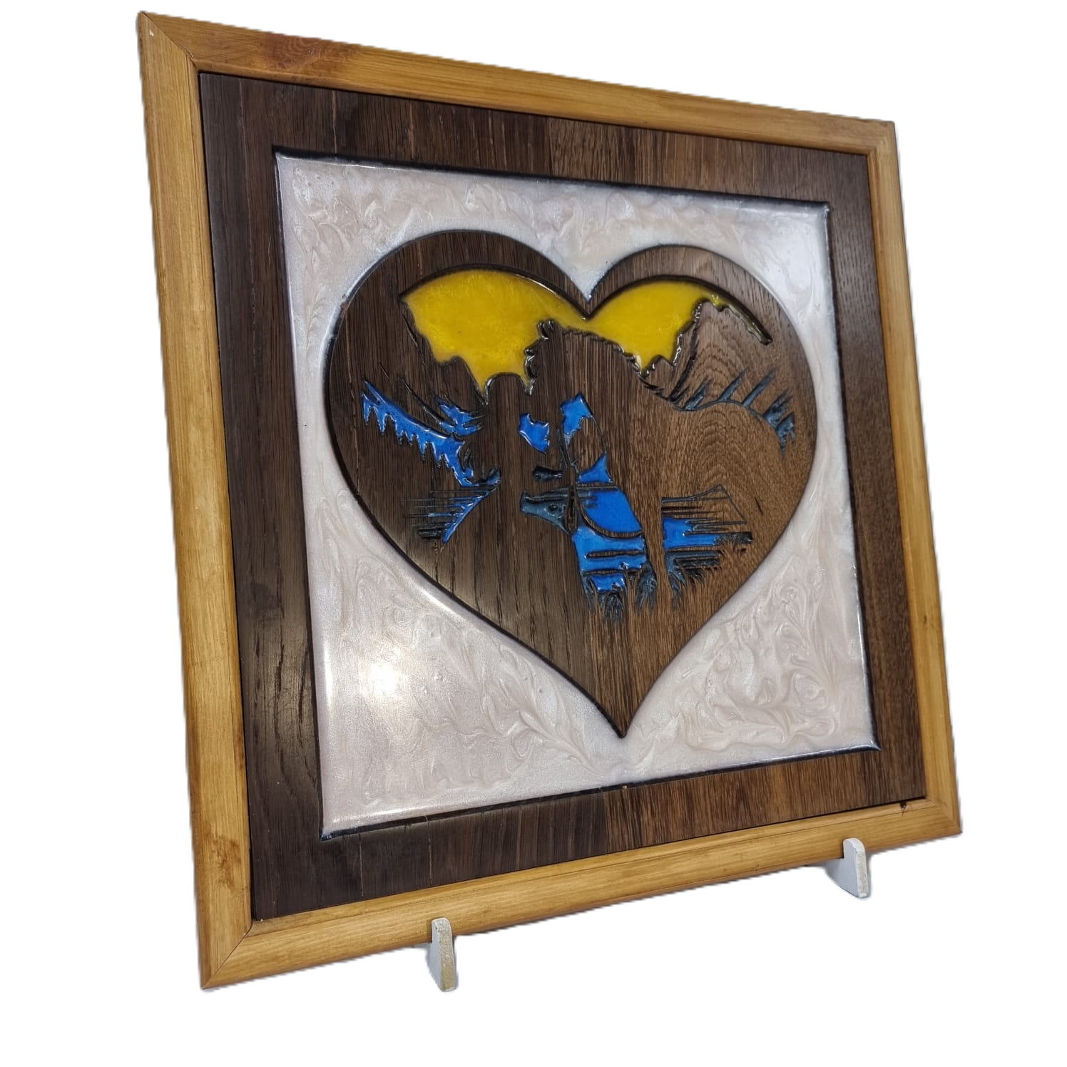 Angled left view of wood and resin heart carving featuring girl and horse