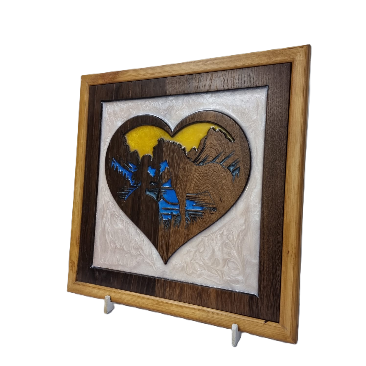 Angled right view of handcrafted wooden heart carving with resin mountain scene