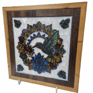 Angle view of handcrafted hummingbird wall art carved from reclaimed oak with vibrant resin inlays.