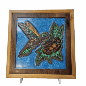 CNC-carved wooden hummingbird artwork with blue resin background, front view