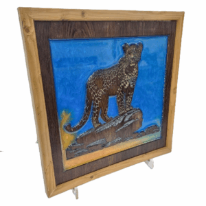 Handcrafted leopard wall art made from reclaimed Corinthia oak flooring with blue and gold resin inlay, shown from an angle.