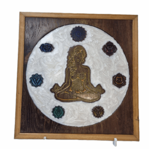 Front view of handcrafted Meditating Woman wall art with seven chakra symbols and white epoxy background.