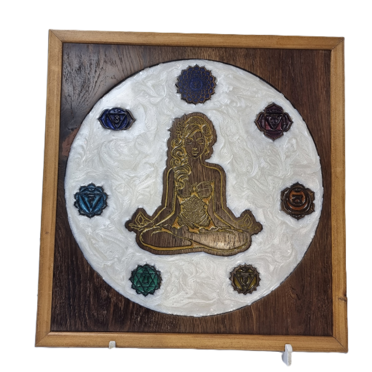 Front view of handcrafted Meditating Woman wall art with seven chakra symbols and white epoxy background.
