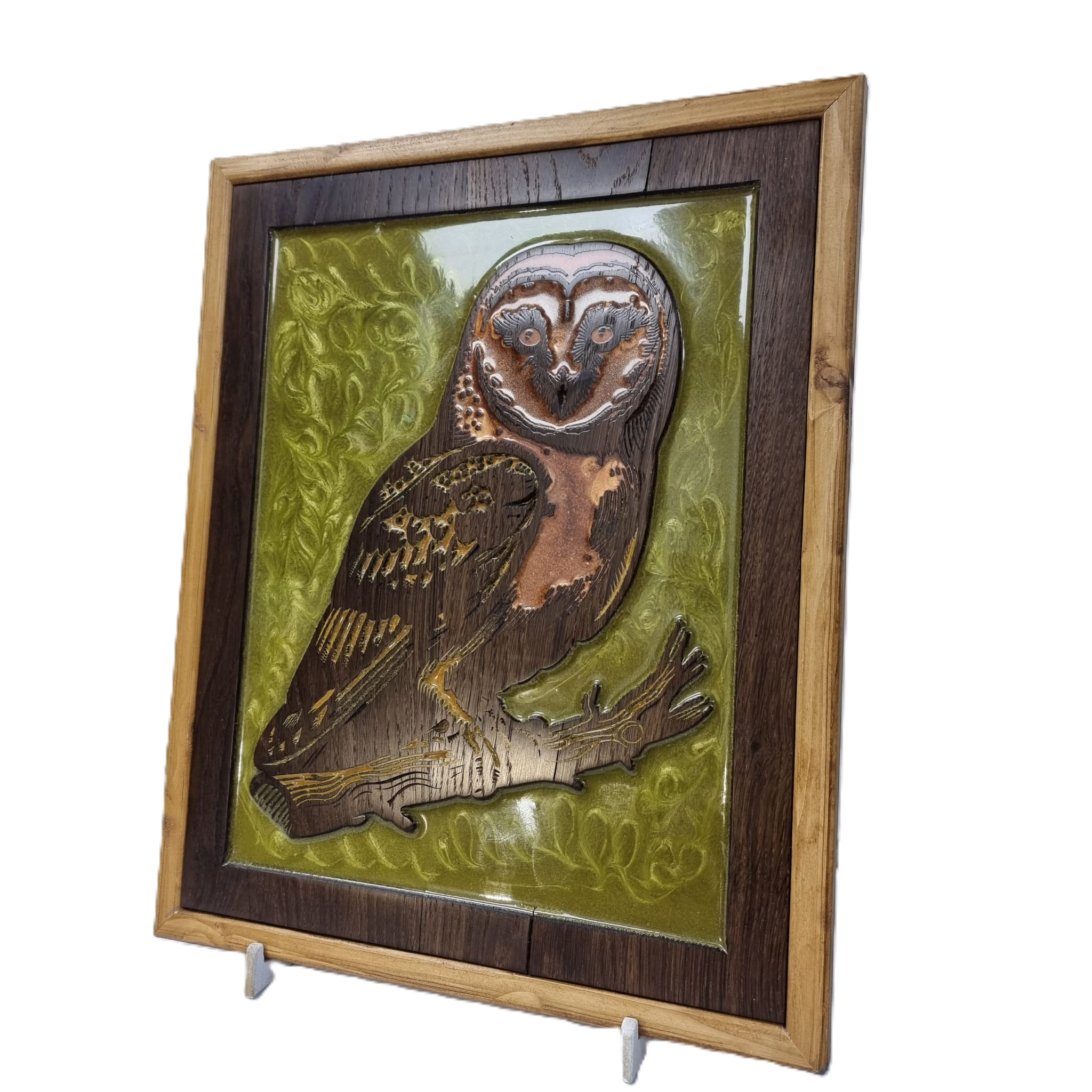 Left angled view of handcrafted owl wall art, highlighting the depth of the wood carving and shimmering green resin background.