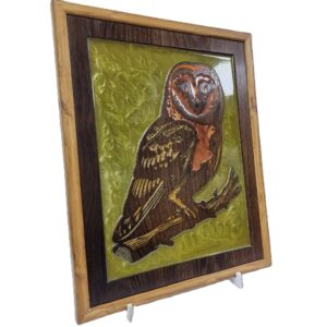 Right angled view of owl wall art, showing the detailed carving, rich wood grain, and glossy green resin inlay.