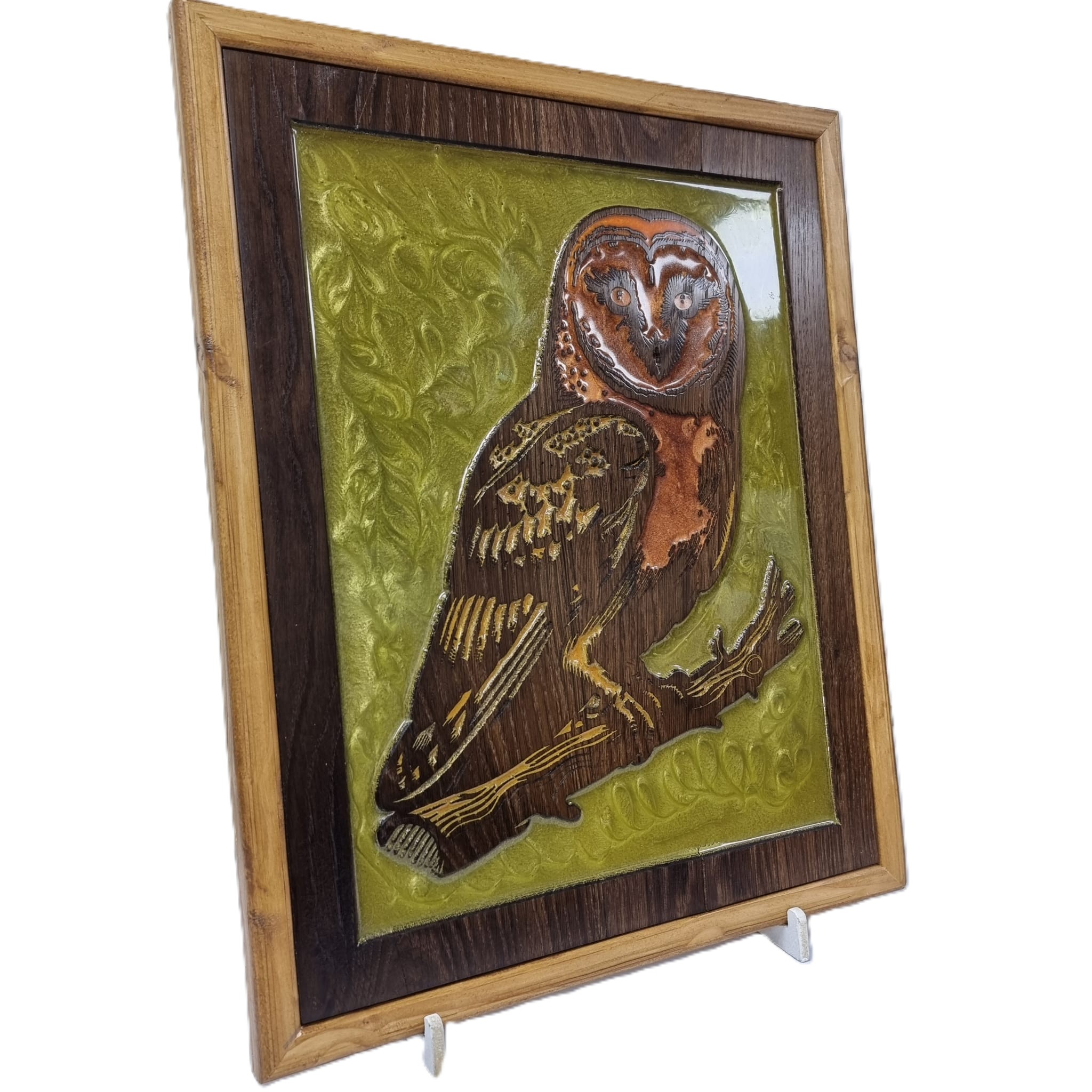 Right angled view of owl wall art, showing the detailed carving, rich wood grain, and glossy green resin inlay.