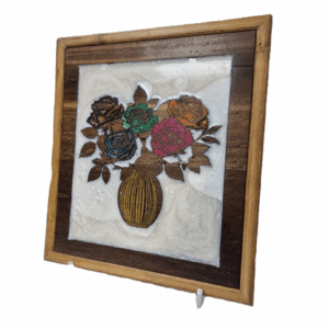 angled view of five roses wall art carved from wood with resin inlay