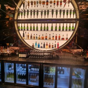 Illuminated champagne display and bespoke bar joinery at Moxy Hotel Piccadilly London by Kustom Made Ltd
