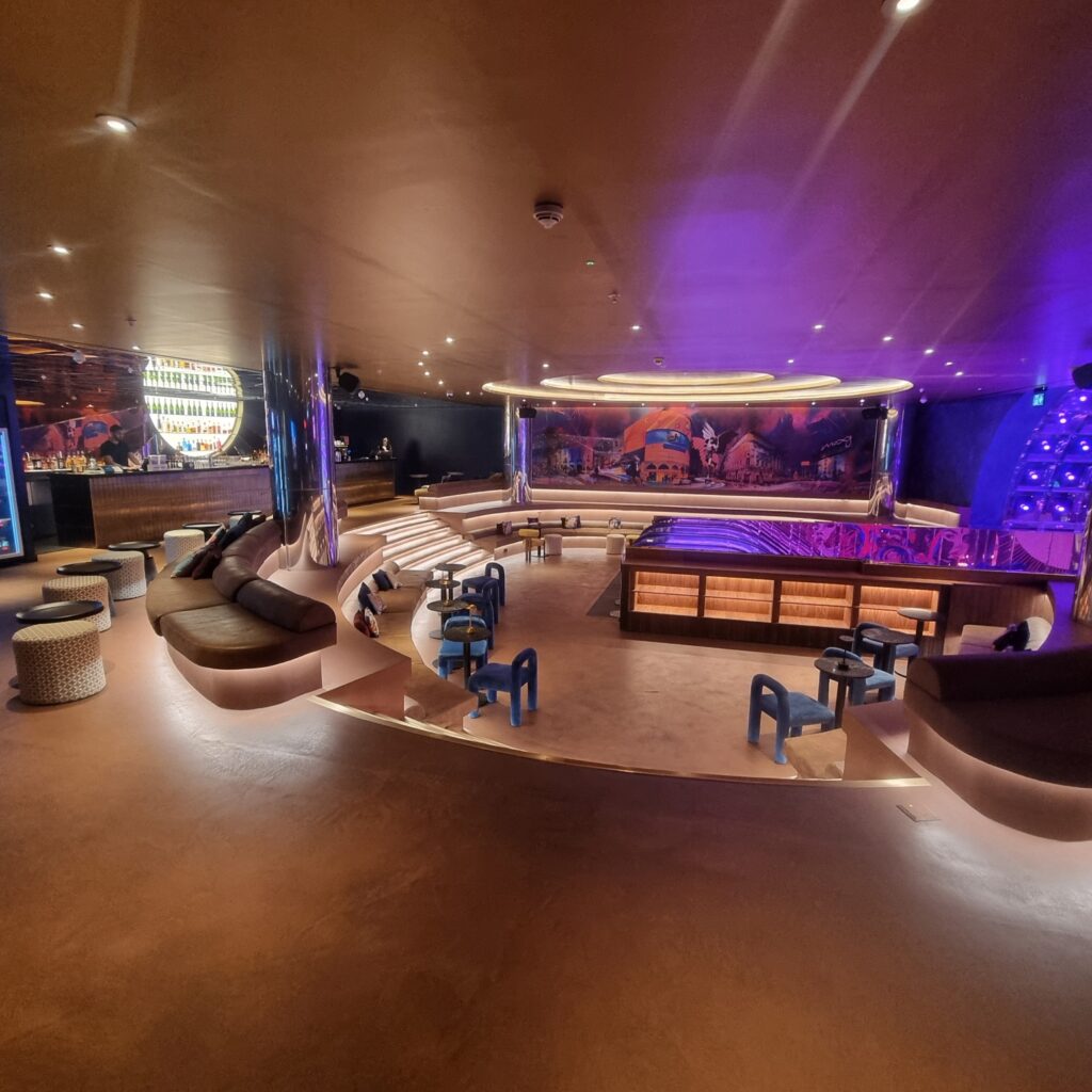 Bespoke bar joinery installation at Moxy Hotel Piccadilly with illuminated champagne display and custom Walnut with ebony trim display units